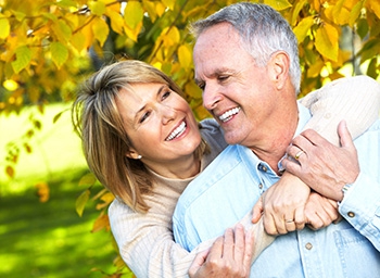 A middle-aged couple smiling